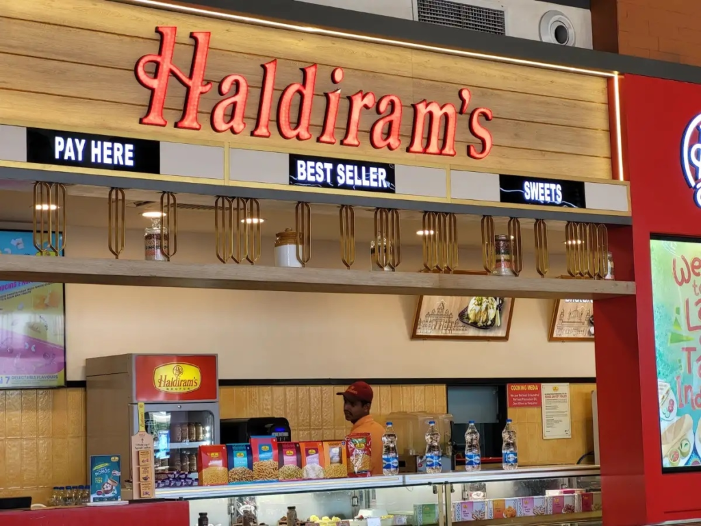 Best Vegetarian Restaurants – Haldiram's restaurant storefront featuring a modern counter, sweets section, and popular vegetarian dining experience in India.