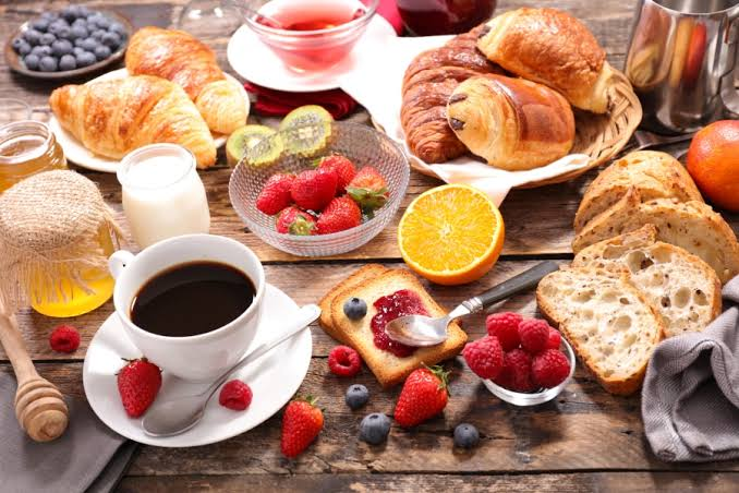 "Modern café interior with wooden décor, indoor plants, cozy seating, and a vibrant coffee-themed ambiance, reflecting the charm of the Famous Cafes in India."
