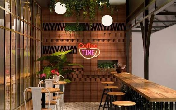 "A cup of coffee on an outdoor café terrace overlooking a breathtaking city skyline, showcasing the scenic ambiance offered by the Famous Cafes in India.